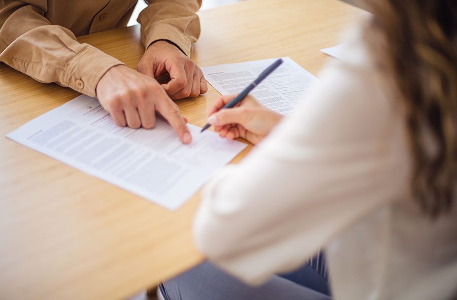 two-people-reviewing-and-signing-a-document-together